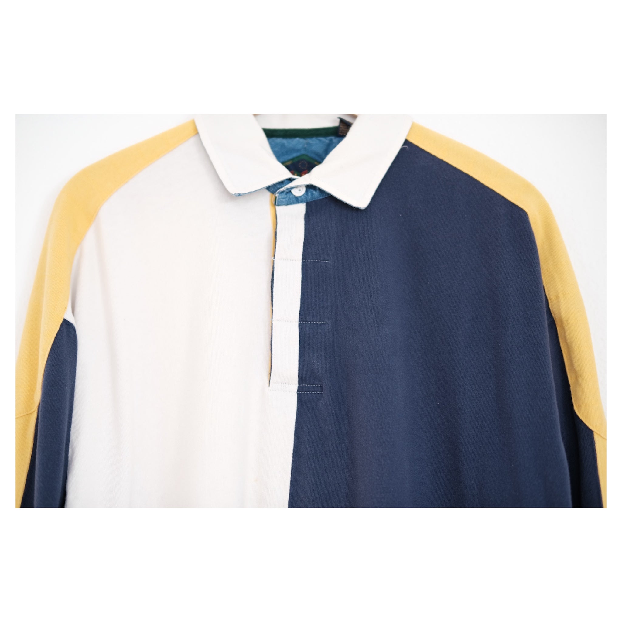 close-up of split-panel rugby collar and two-button placket with contrast construction