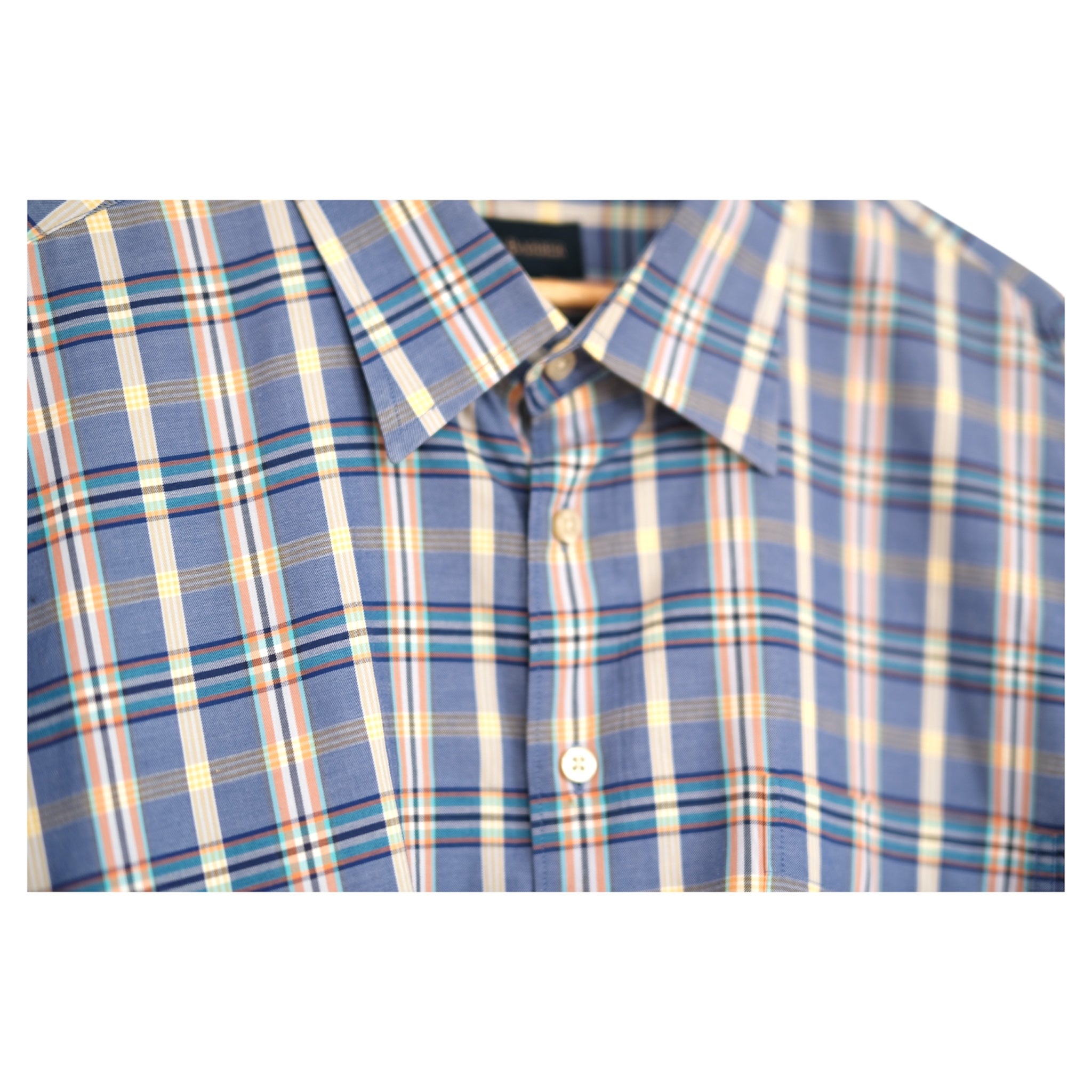 close-up of slate blue madras check cotton fabric with collar detail
