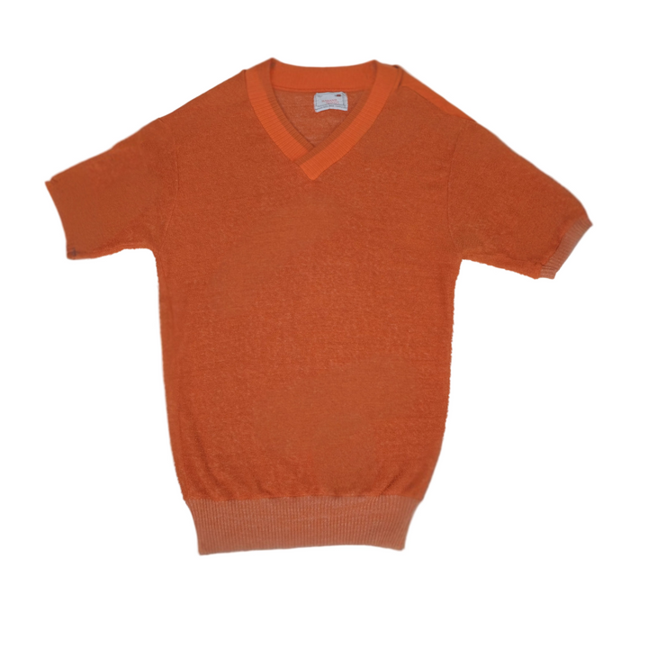 Orange sweater on a light gray background