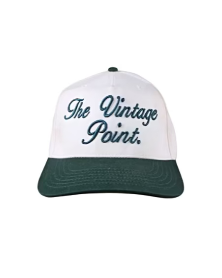 Cream cap with green brim and 'The Vintage Point' text on a cream background