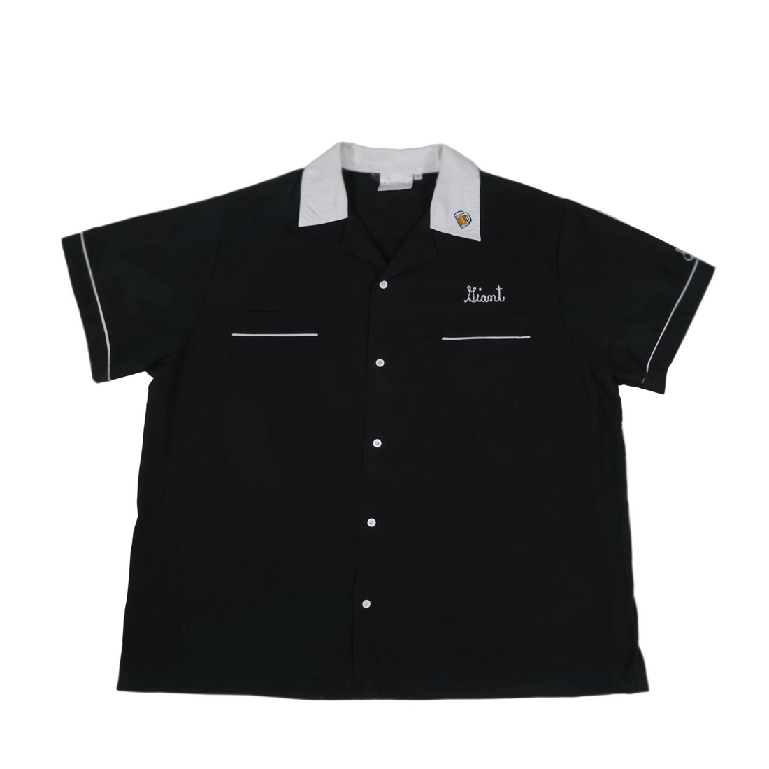 Black short-sleeve shirt with white trim on a beige background