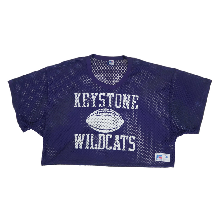 Purple mesh sports jersey with 'Keystone Wildcats' text on a beige background