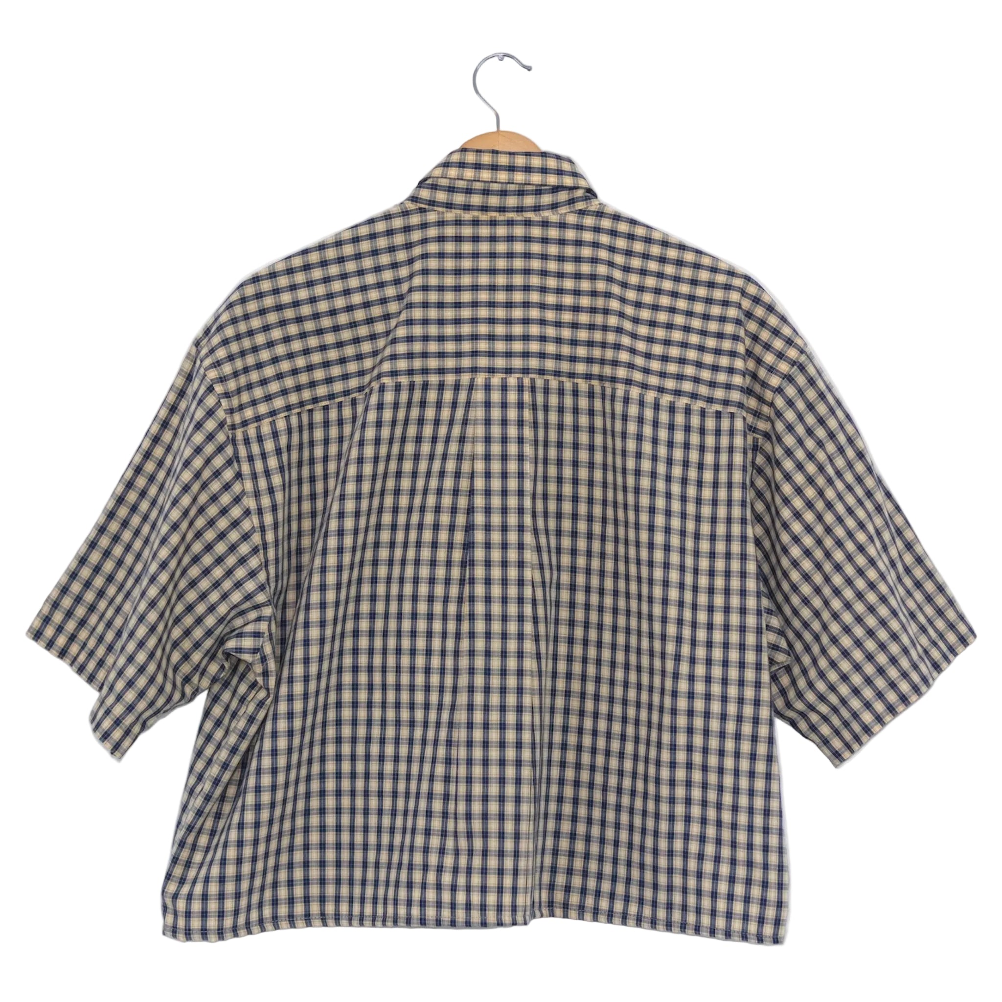 Plaid shirt on a hanger against a white background