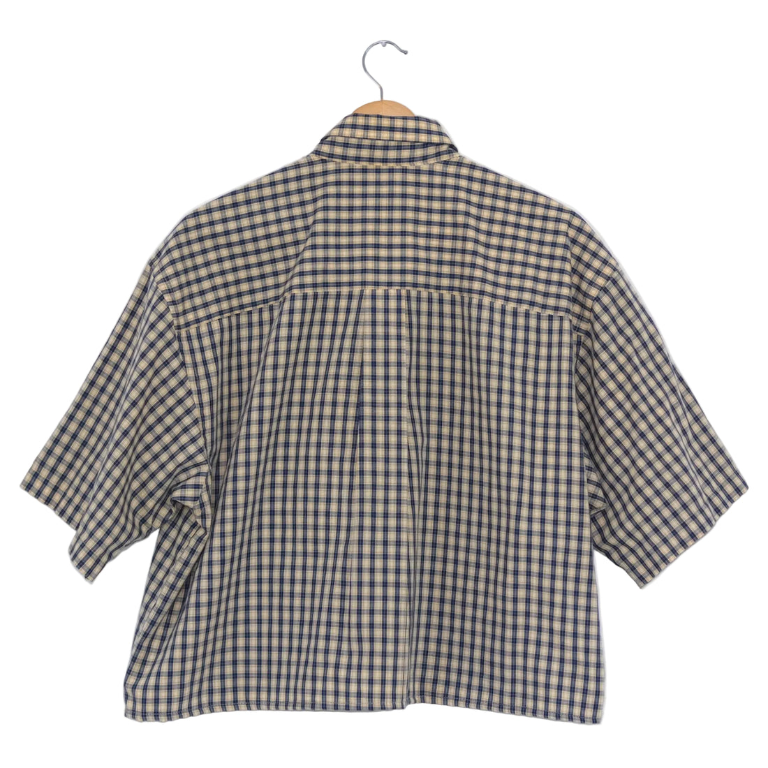 Plaid shirt on a hanger against a white background