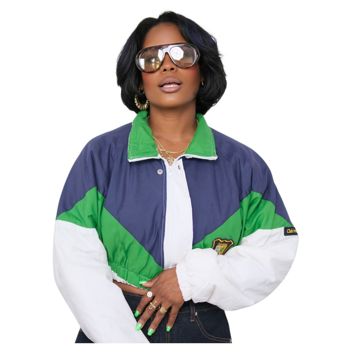 Woman wearing a colorful cropped jacket with a white background