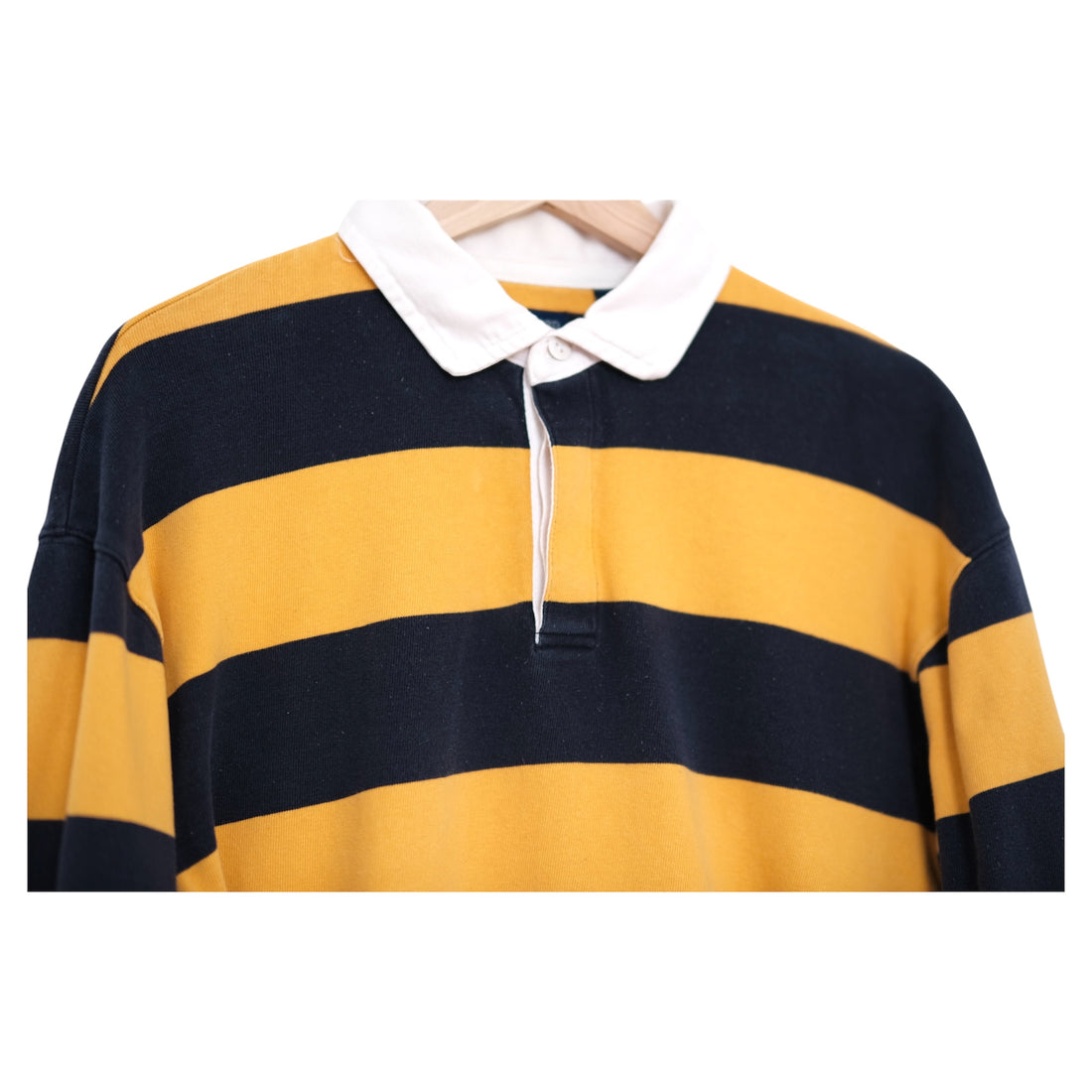 Yellow and navy striped rugby shirt with white collar on a white background
