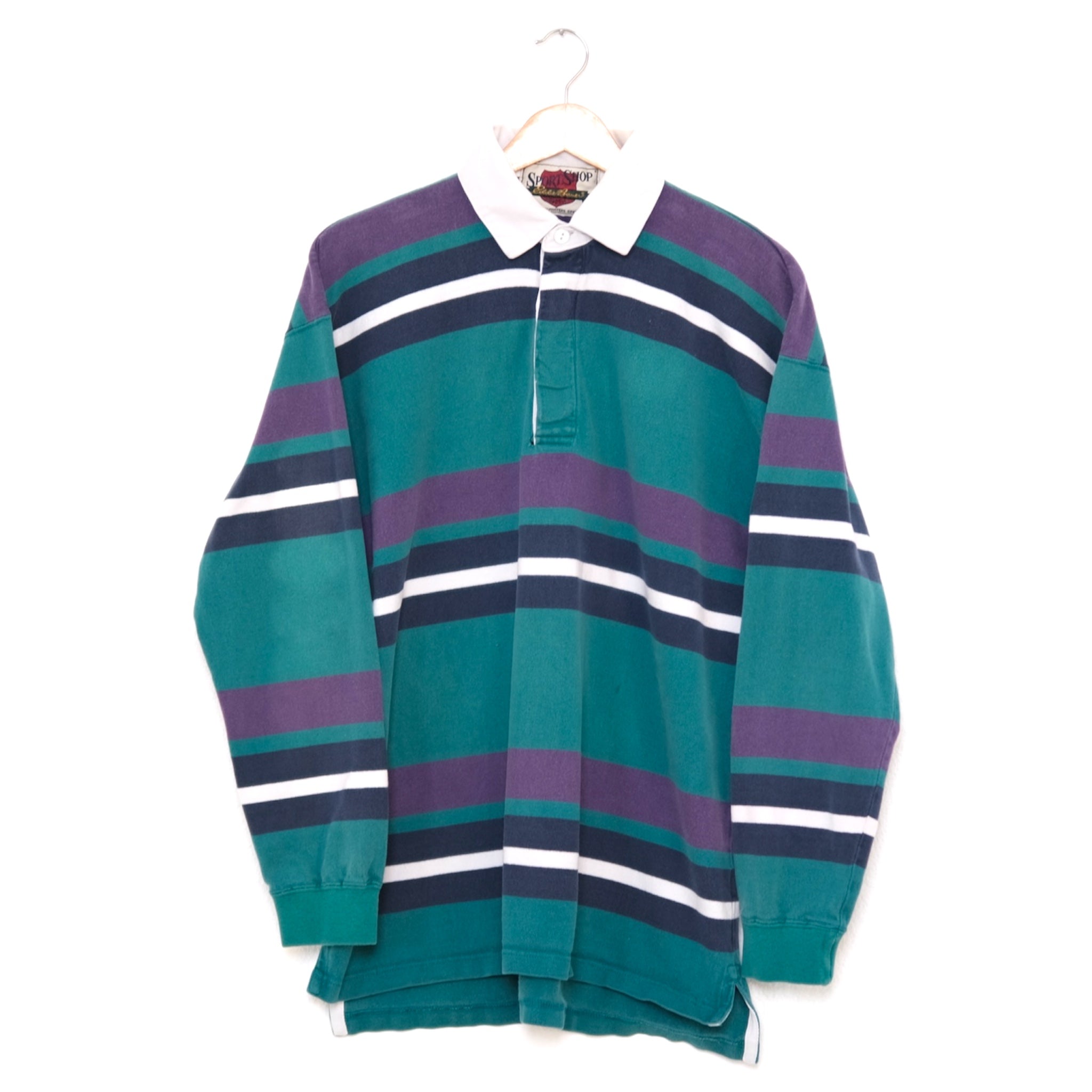 vintage 90s rugby in teal, plum, midnight and shell graphic stripes with shell contrast collar, on a wood hanger