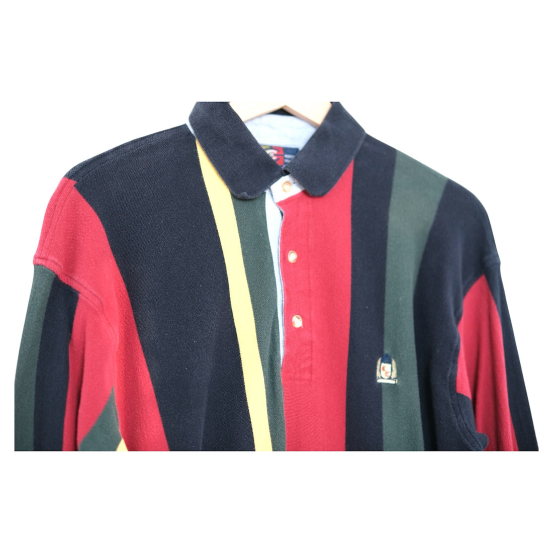 close-up of rugby collar with three-button placket and chambray facing, embroidered chest detail